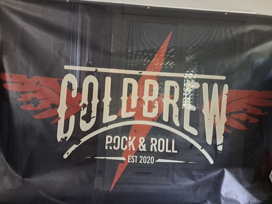 A large black banner with a band logo in white and red