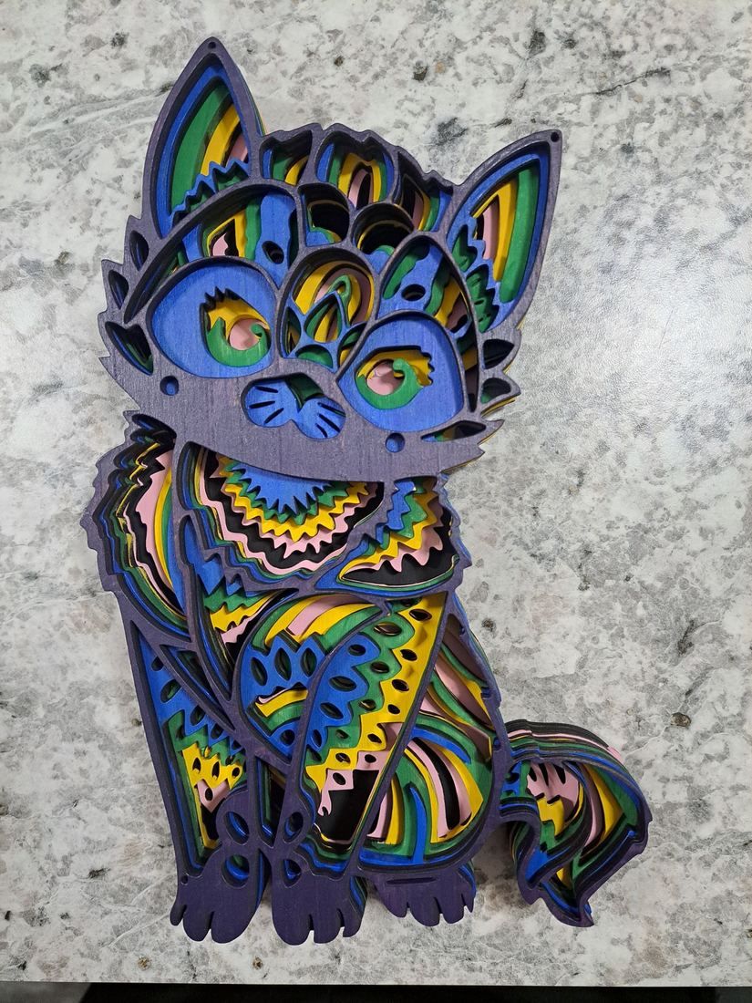 A colourful layered wooden cat, cut on the laser in many stacked layers